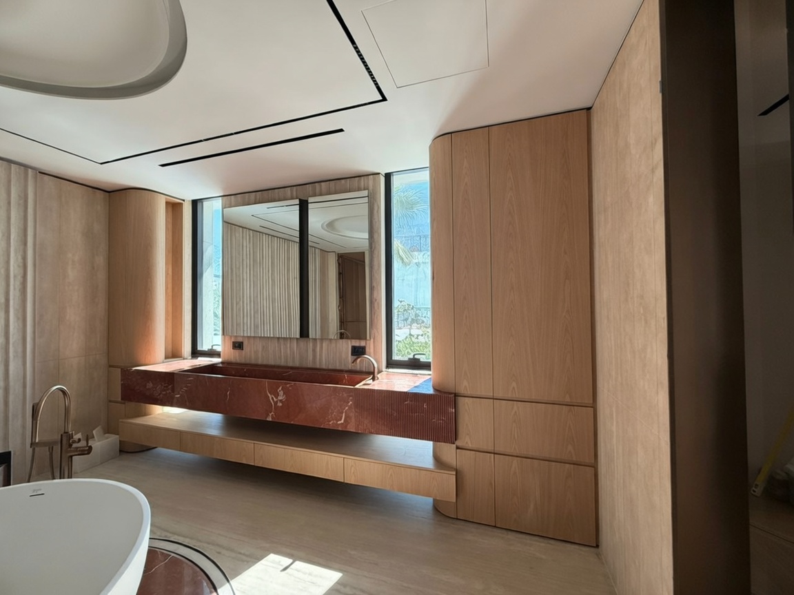 Spa-style bathroom with stone vanity and wood panelling by Mistry Interiors